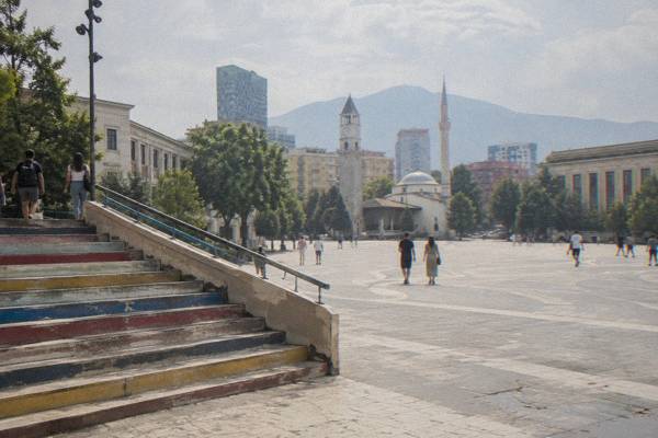 A painted staircase and a, a few people walking up, Skanderbeg Square