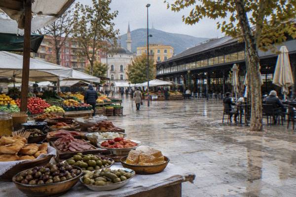 A market table covered with small tasting plates, olives, cured meats, honeycomb, pickles and fried dough, New Bazaar
