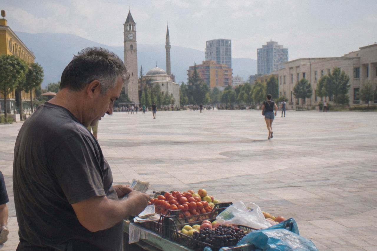 A market stall vendor in Tirana counting Albanian lek banknotes