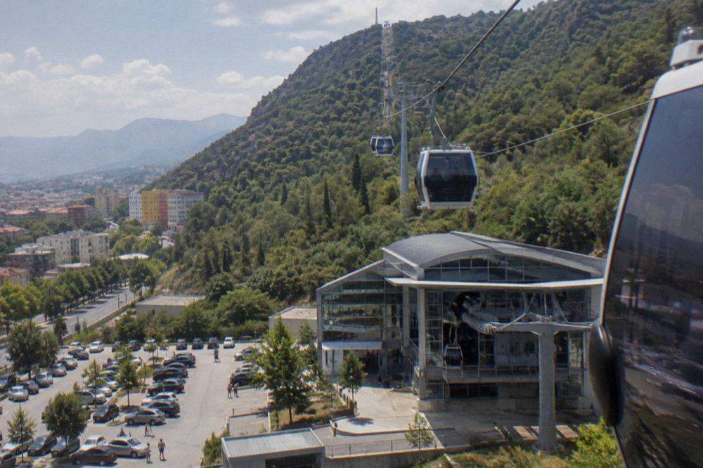The Dajti Ekspres cable car cabins travelling up the forested slope of Mount Dajti above Tirana