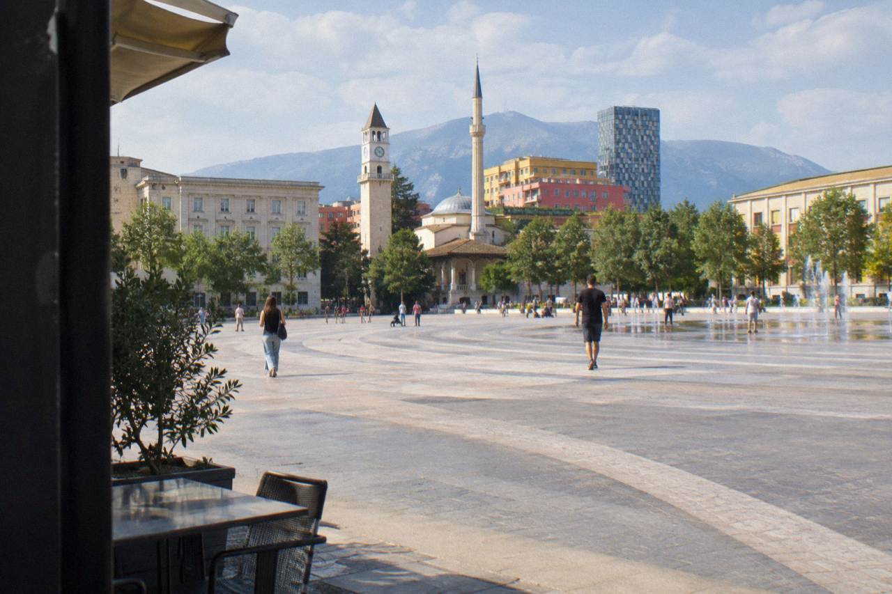 Colourful facades and mosque minarets around a square in central Tirana