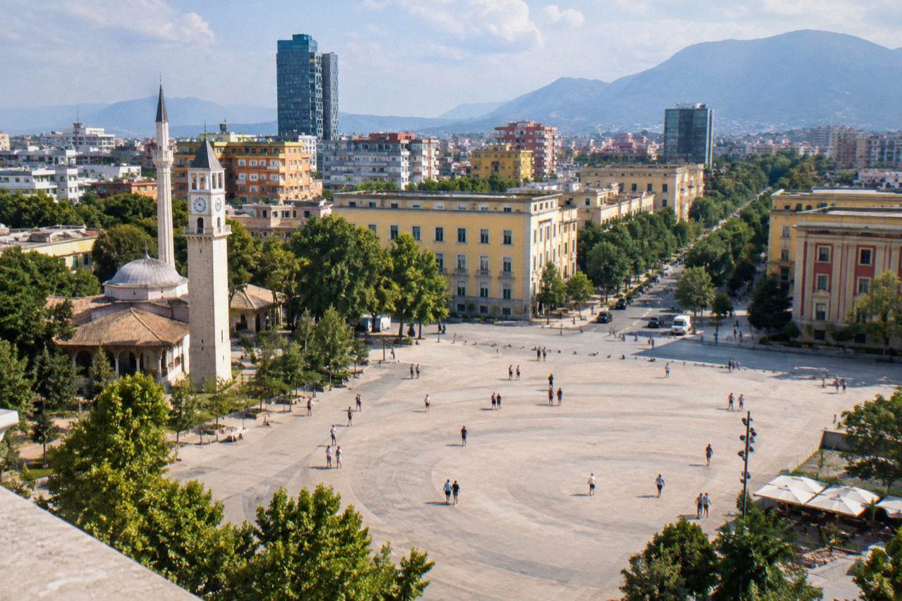 Skanderbeg Square in Tirana seen from above on a clear day, with the Clock Tower and city rooftops