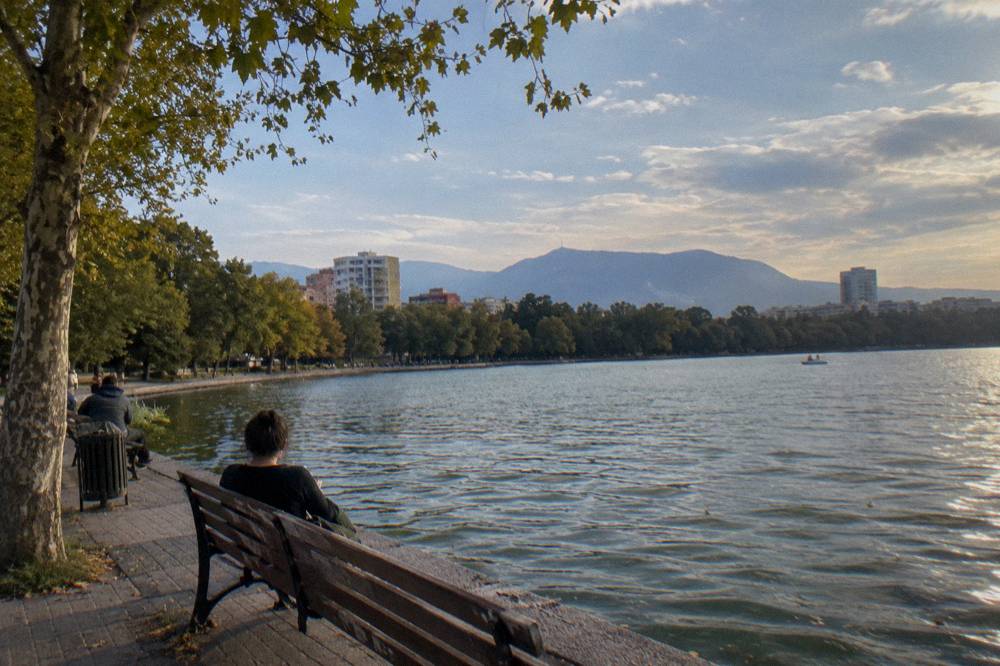 Afternoon light on the water of the Artificial Lake in Tirana with trees along the shore