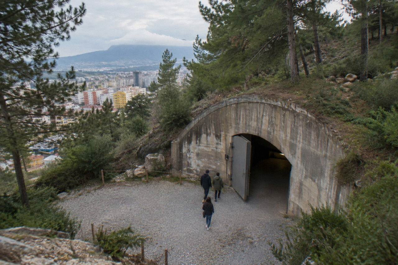 The long concrete tunnel entrance of the Bunk'Art 1 bunker museum cut into a hillside on the edge of Tirana
