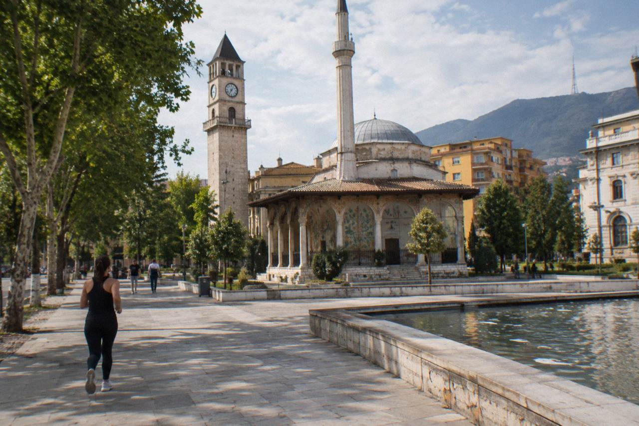 The stone Clock Tower of Tirana rising beside the minaret of Et'hem Bey Mosque on Skanderbeg Square