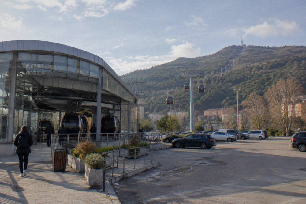 The modern lower station building of the Dajti Ekspres cable car with cabins parked on the line