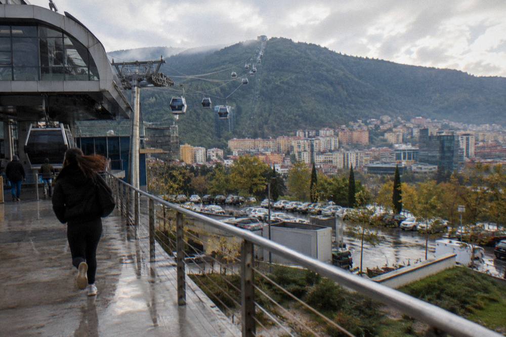 Evening light over Tirana's rooftops with the forested ridge of Mount Dajti behind the city