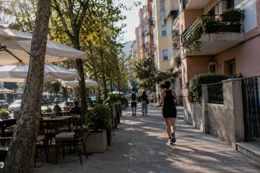 An apartment building facade with balconies along a Blloku street