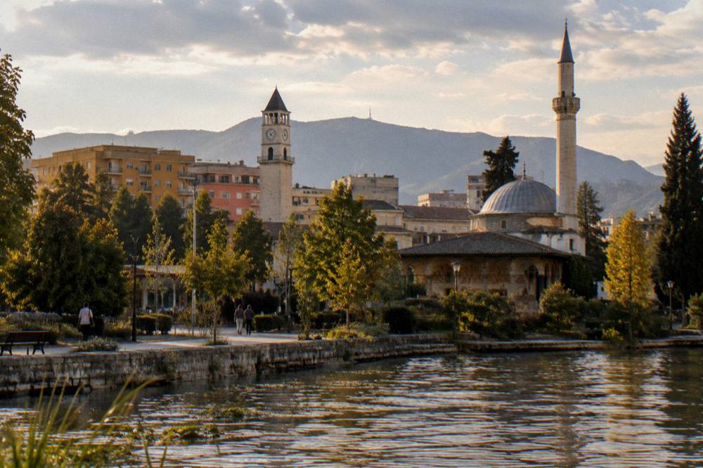 The mosque seen from a distance with the Clock Tower above the rooftops of Tirana