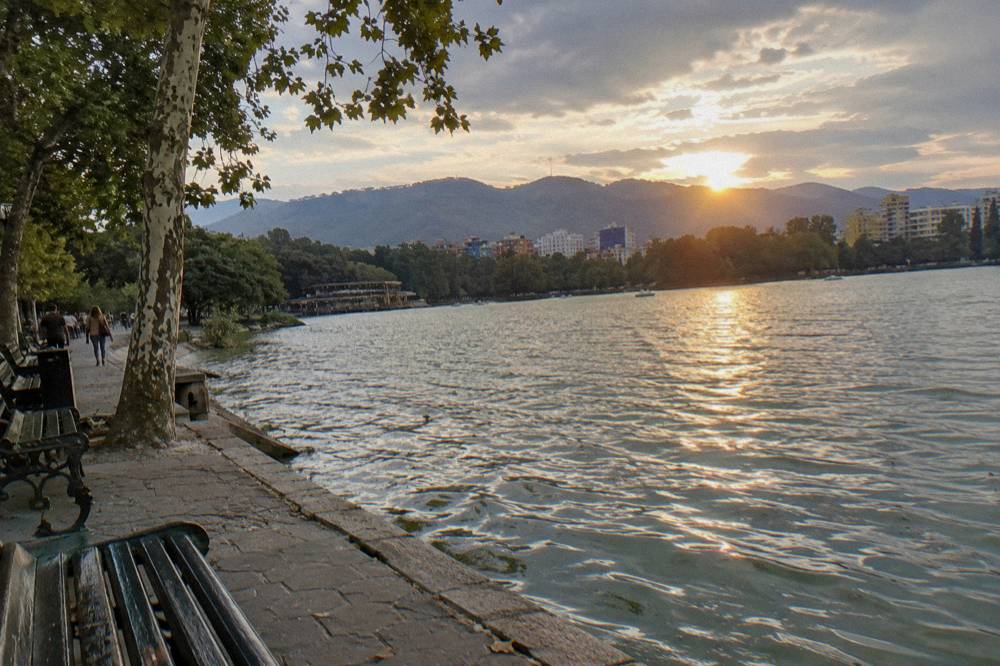 The Artificial Lake in Tirana at sunset with the hills behind the water glowing