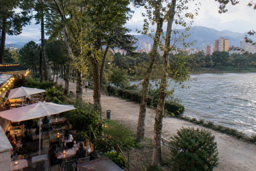 Cafe tables and evening lights in the Blloku quarter of Tirana near the Grand Park