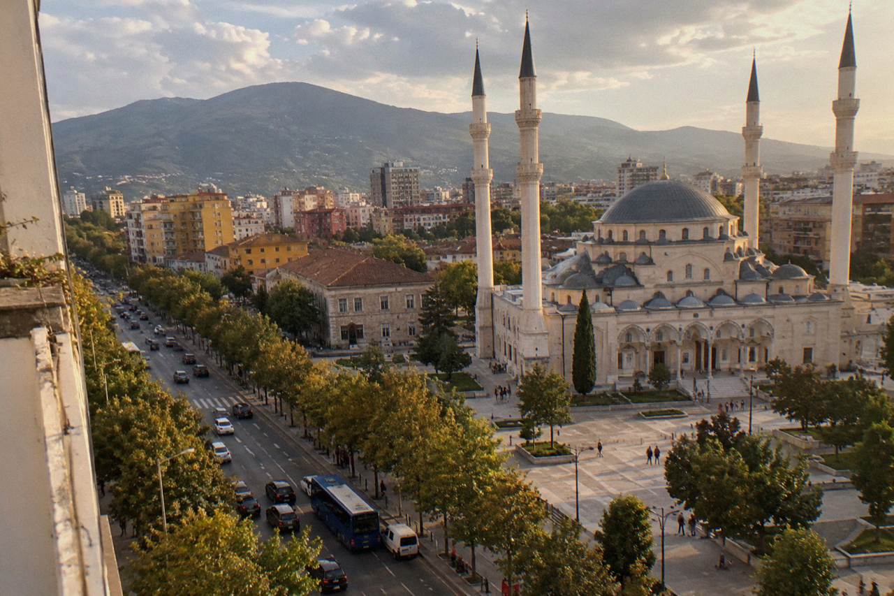 The large domed Namazgah Mosque seen from a street in central Tirana
