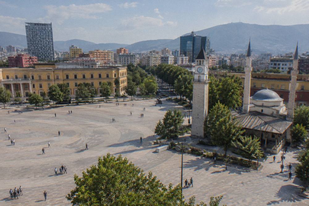 The mosque's courtyard and minarets under a clear sky in Tirana