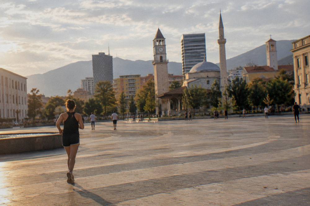 Tirana cityscape with the mosque dome and church towers visible in the same view