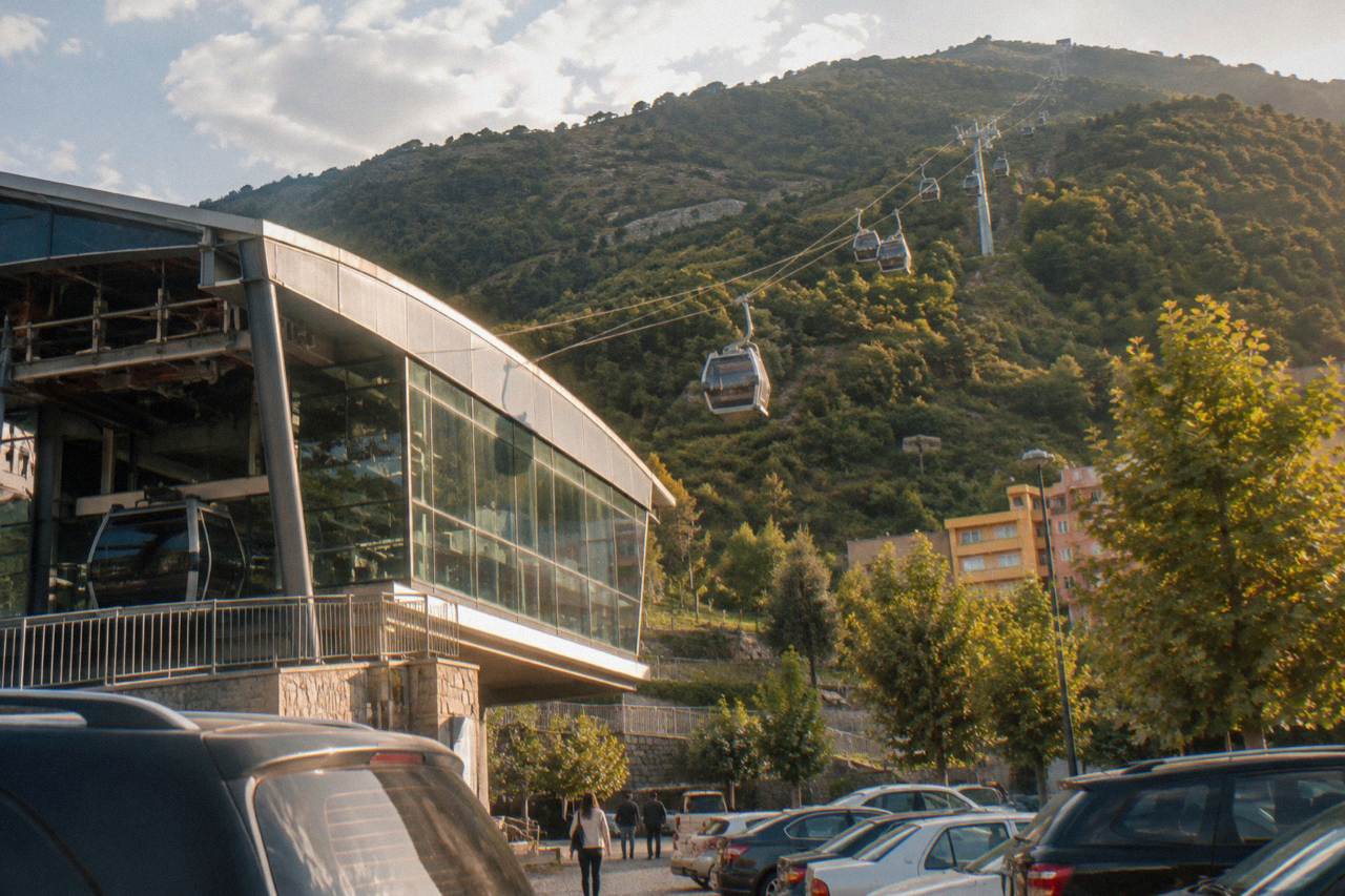 Cable car cabins travelling up the forested slope of Mount Dajti above Tirana