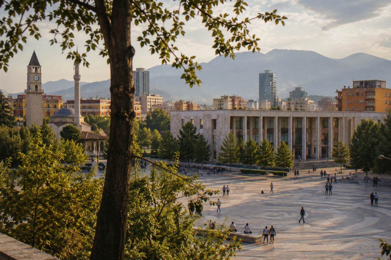 Gallery building in central Tirana seen from the street, with trees in the foreground