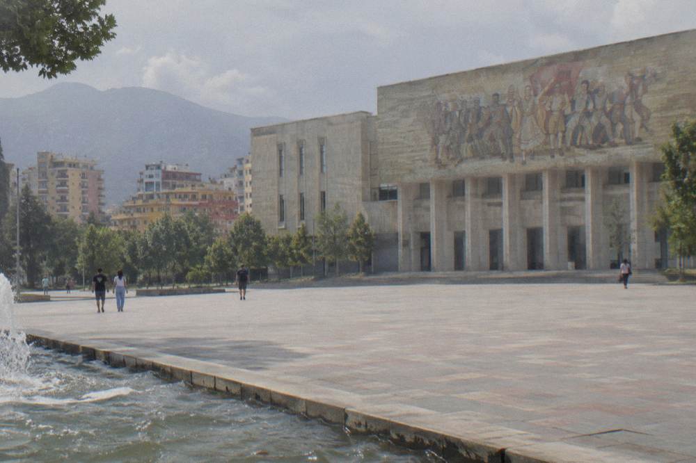 The long stone frontage of the museum building seen from the edge of the square