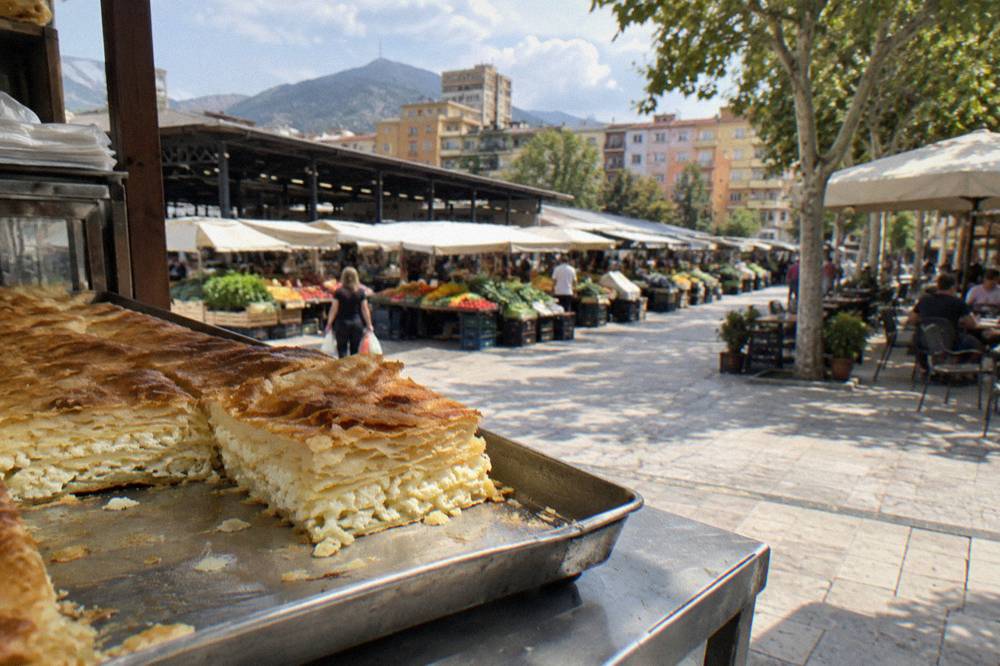 Close view of a slice of byrek, a layered filo pie with cheese, on a market counter