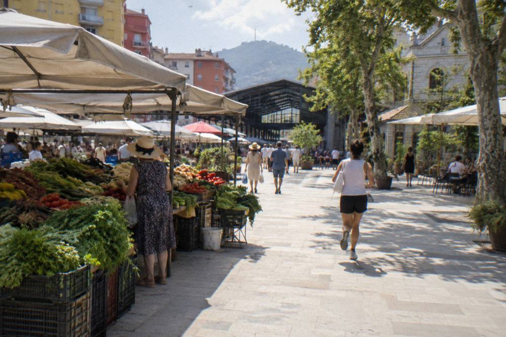 Market stall of fresh vegetables and herbs in summer light at the New Bazaar in Tirana