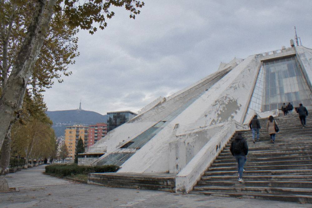 Visitors walking up the external steps on the side of the Pyramid of Tirana