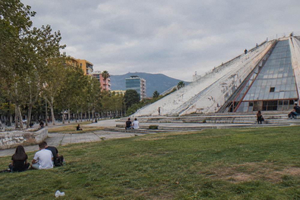 People relaxing on the lawn and steps around the Pyramid on a warm afternoon