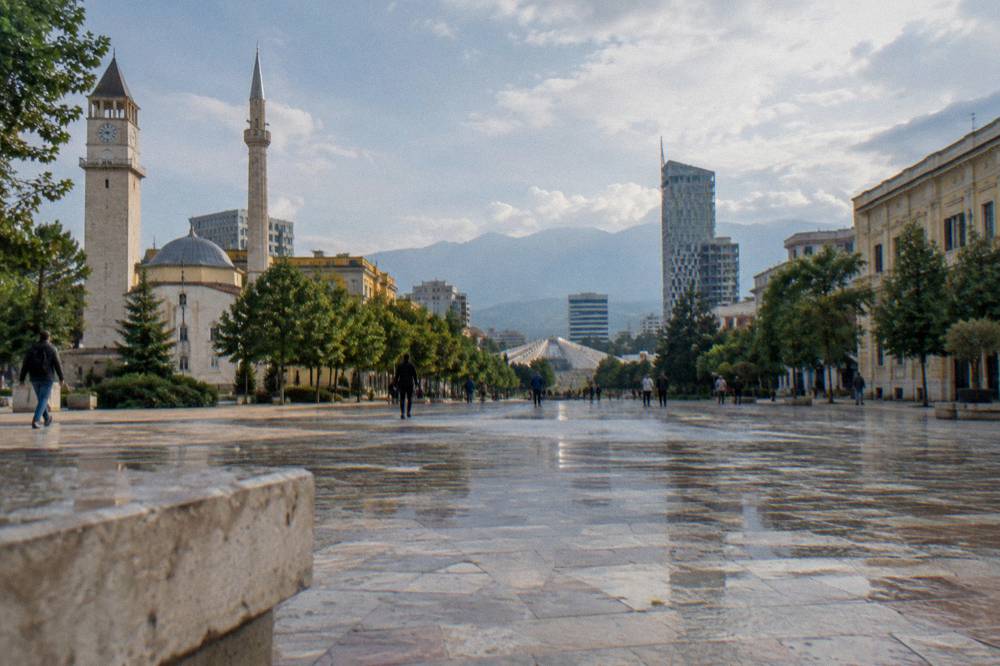 The main boulevard in Tirana with the Pyramid visible among trees ahead