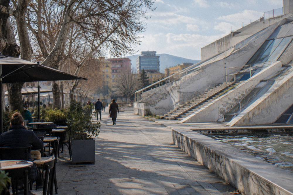 A cafe-lined street near the Pyramid with tables out on the pavement