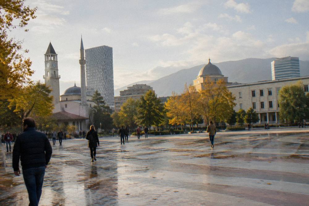 Sunlight on the cathedral dome above autumn trees in central Tirana