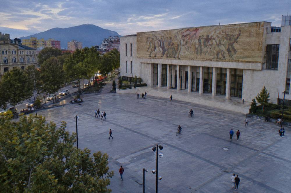 The mosaic facade of the National History Museum above the edge of the square