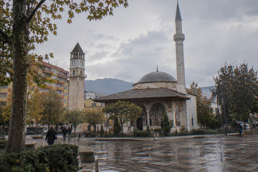 The Ottoman-era Et'hem Bey Mosque and Clock Tower rising above the edge of the square