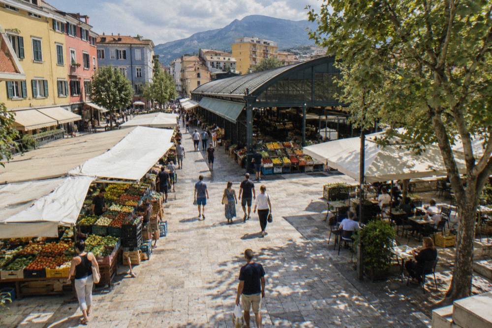 Colourful market street buildings of the New Bazaar in Tirana with people walking