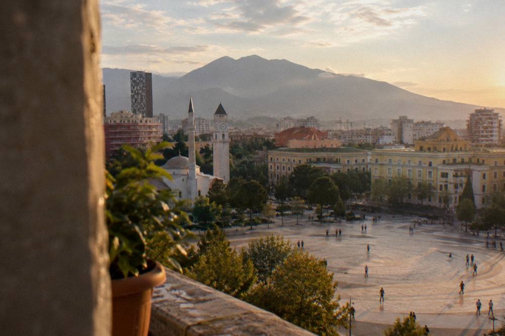 View over Tirana rooftops toward the hills of Mount Dajti at the edge of the city
