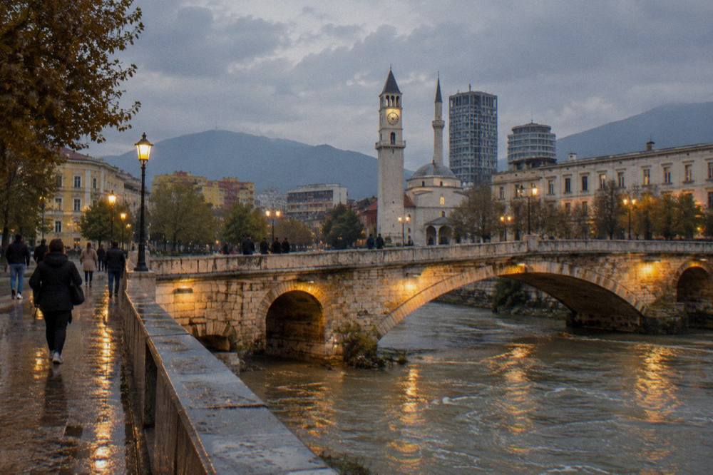 Evening light on an old stone bridge with warm lamps in a Tirana street