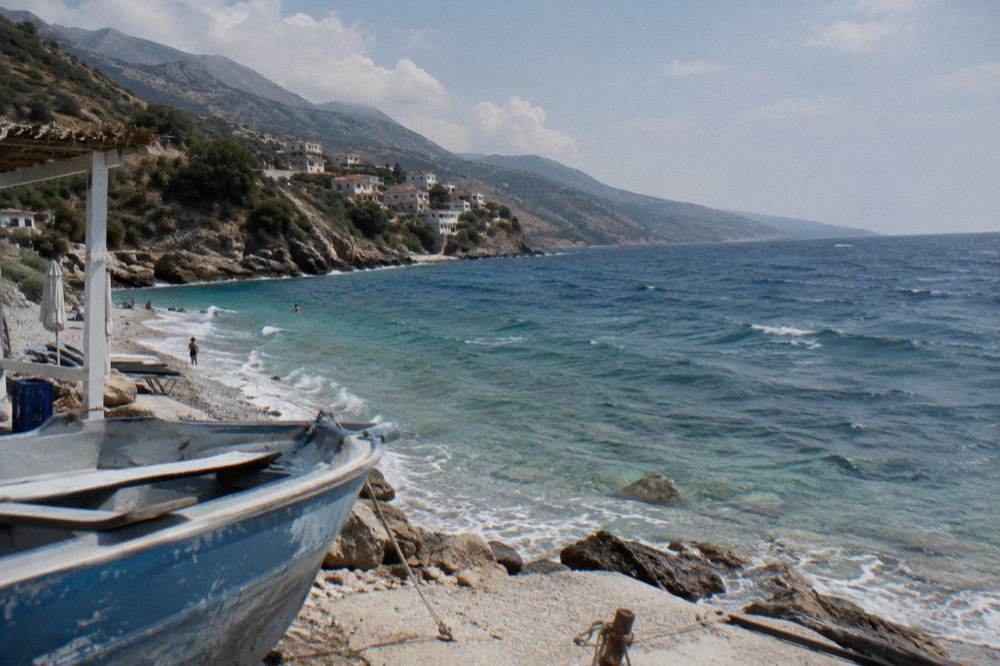 Clear turquoise water over pale pebbles at a small cove