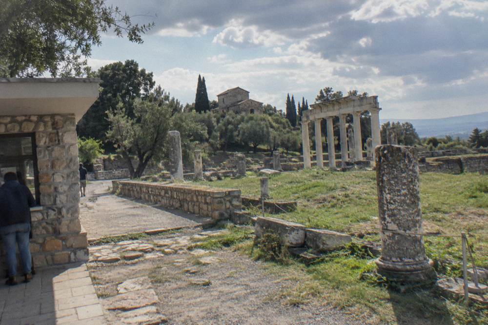 A stone ticket area and pathway at the entrance to ruins