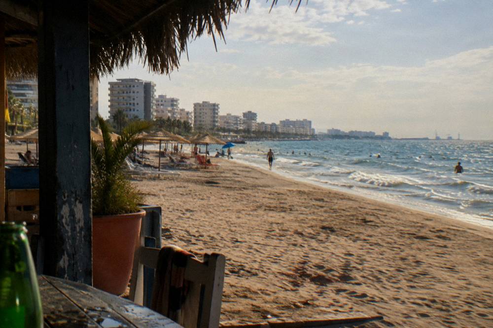 Wide sandy beach at Durres with umbrellas and calm Adriatic water