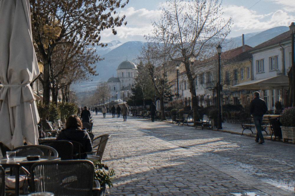 Cafe tables set out along a cobbled pedestrian street