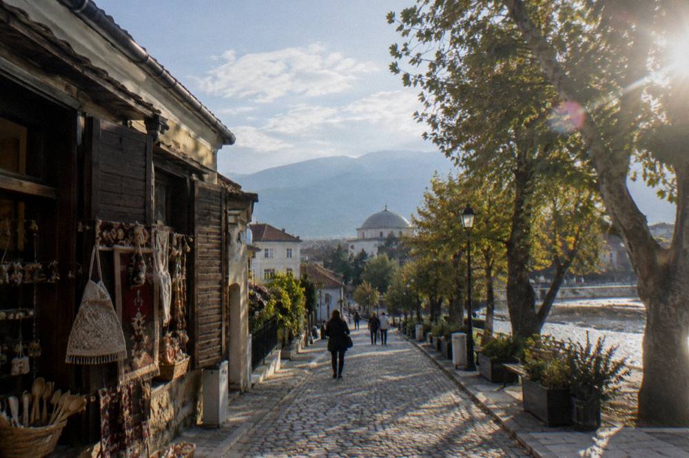 Handicraft shopfront with wooden shutters on a narrow cobbled street