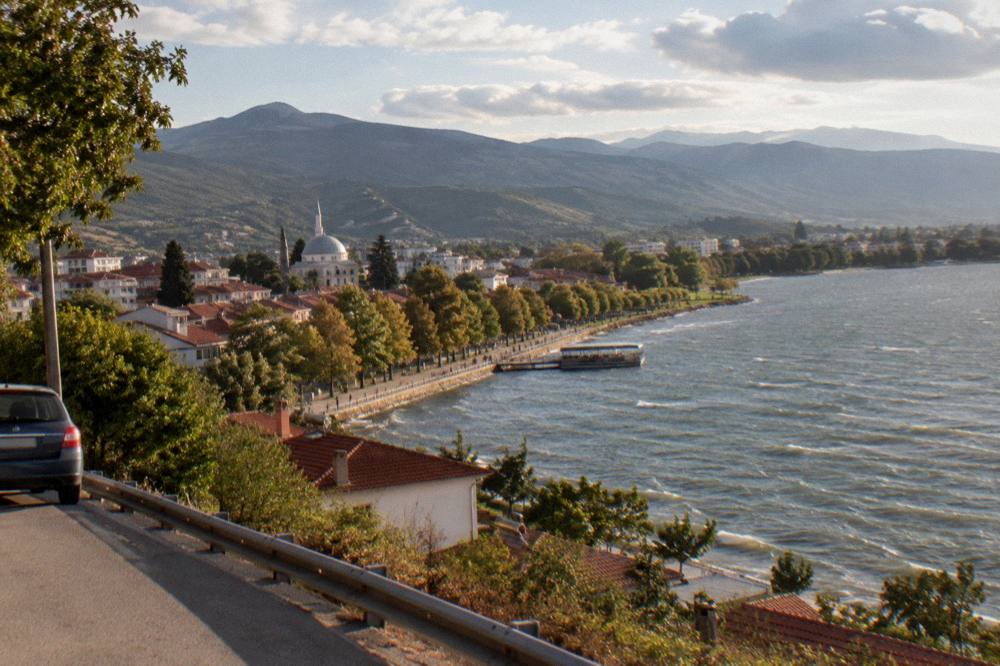 Green hills and a town skyline in south-eastern Albania seen from a road