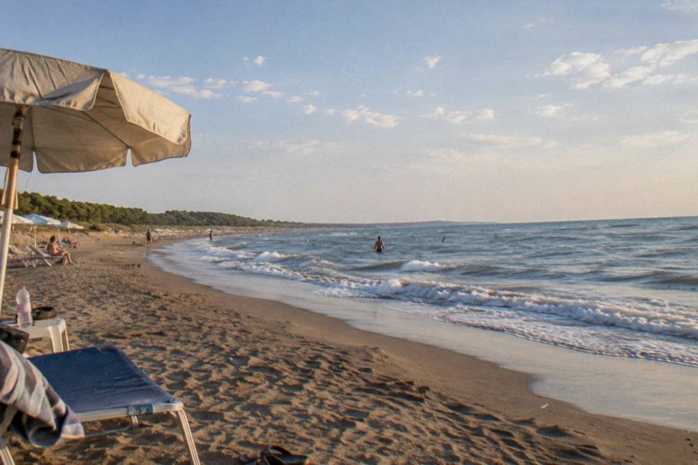 A quiet beach at golden hour with soft light across the sand and gentle waves