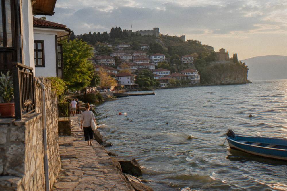 Narrow stone-paved streets of an old lakeside town with traditional houses