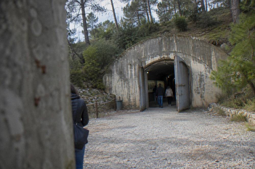 A concrete bunker museum entrance built into a hillside on the edge of Tirana