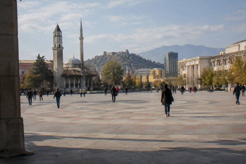 A hilltop castle above a plain with mountains in the distance near Tirana