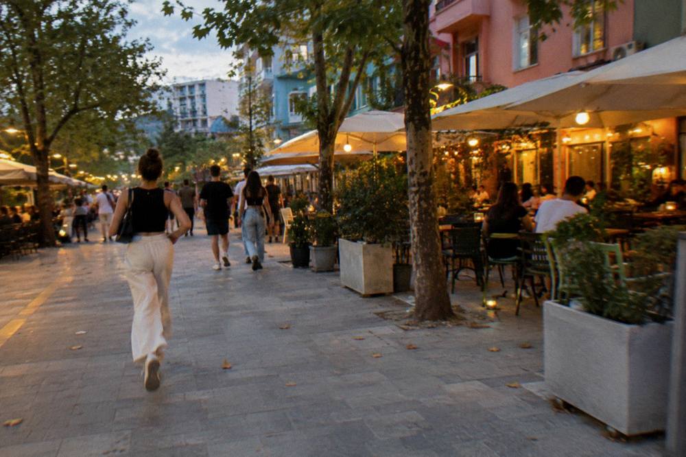 Evening lights over a busy cafe street in the Blloku district of Tirana
