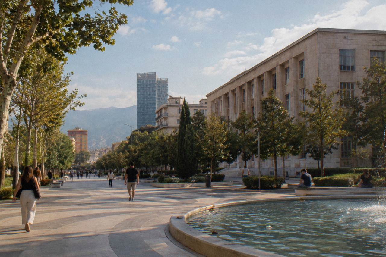 Bank of Albania building seen from a tree-lined street in central Tirana