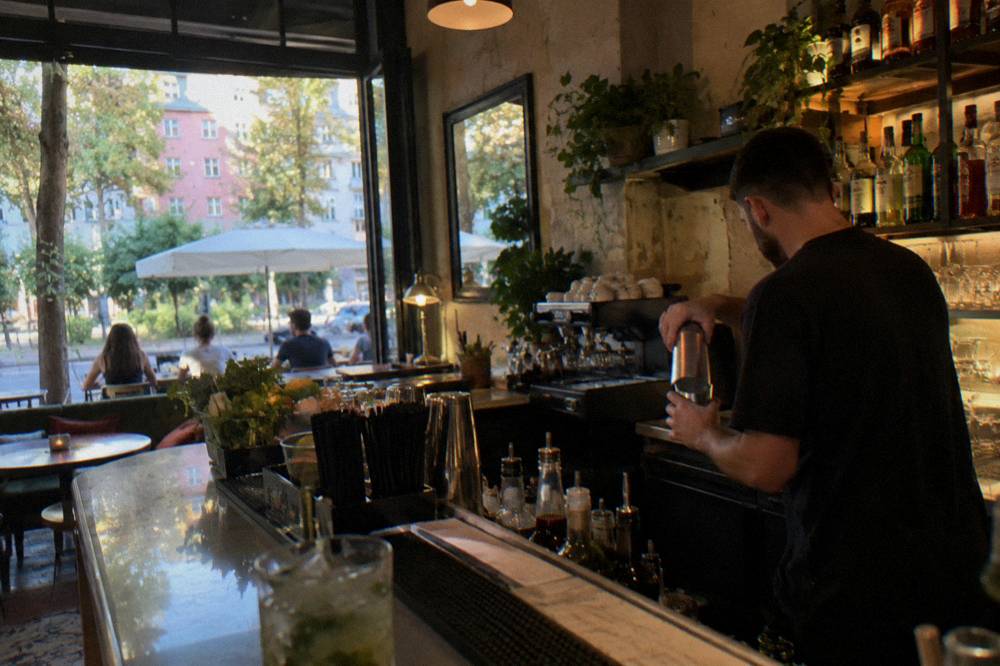 A bar interior in the Blloku quarter of Tirana with a bartender preparing drinks
