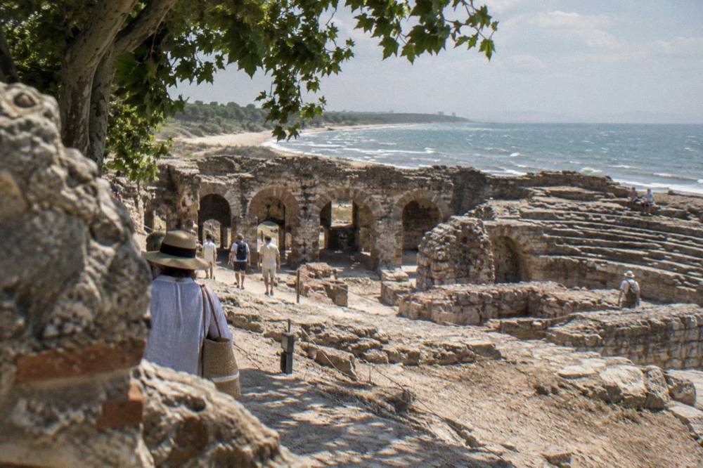An ancient stone Roman amphitheatre with arched passages open to the sky