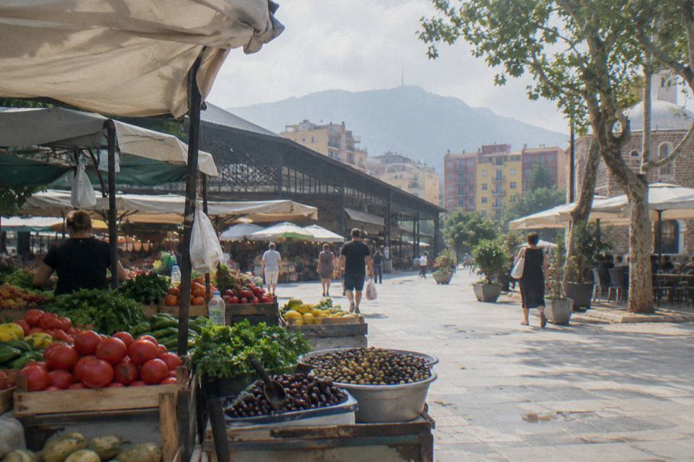 Market stalls with fresh vegetables and olives at the New Bazaar in Tirana