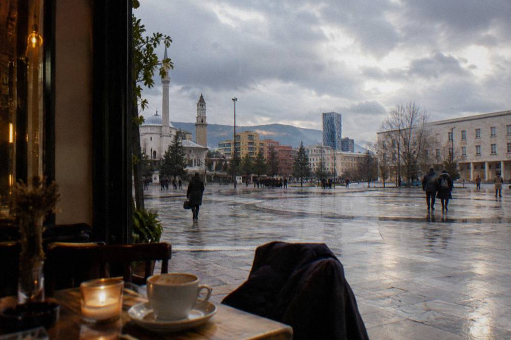 A candlelit cafe interior with warm lights in Tirana in winter