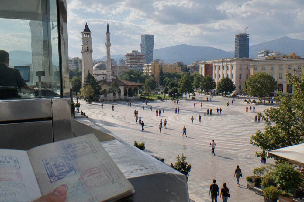 A border control desk with passport stamps at Tirana airport